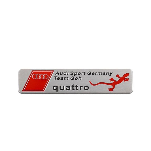Алуминиева емблема Quattro – лепяща, 120 × 26 мм